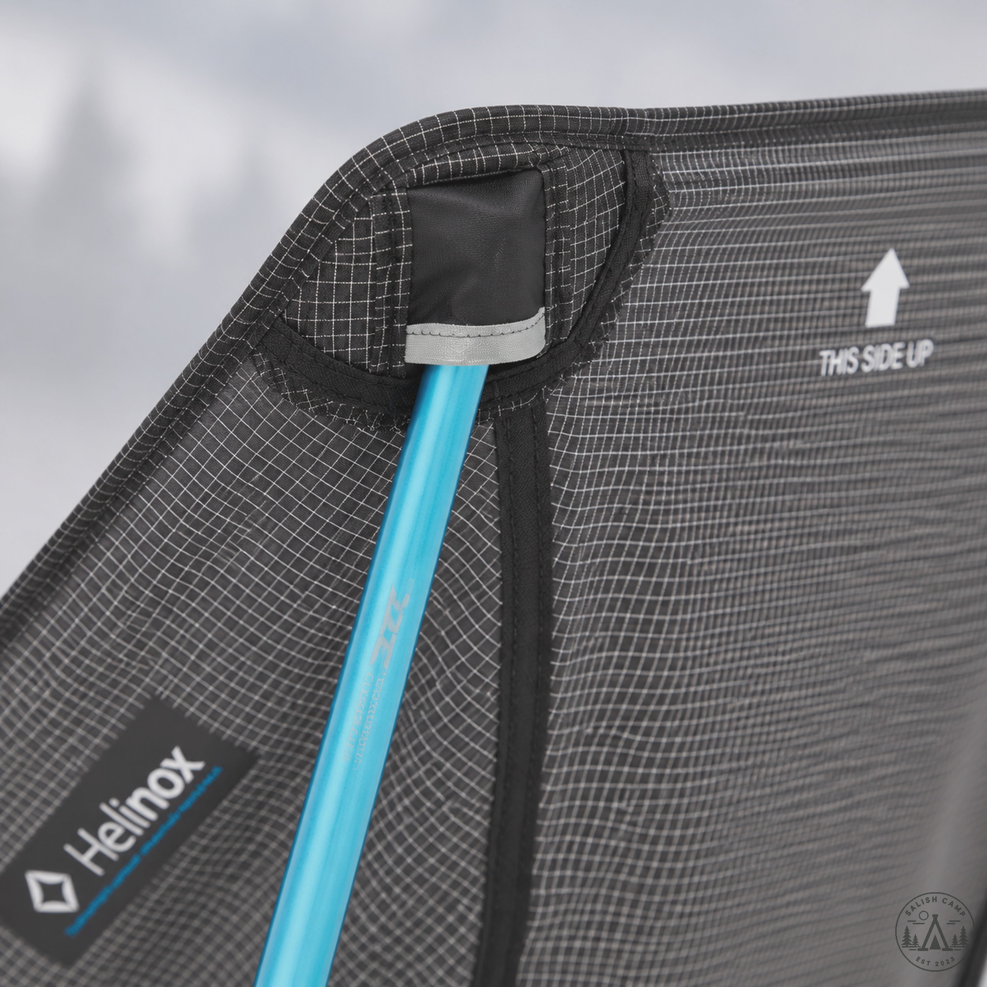 Cyan DAC pole inserted into Helinox Chair Zero black ripstop seat corner pocket