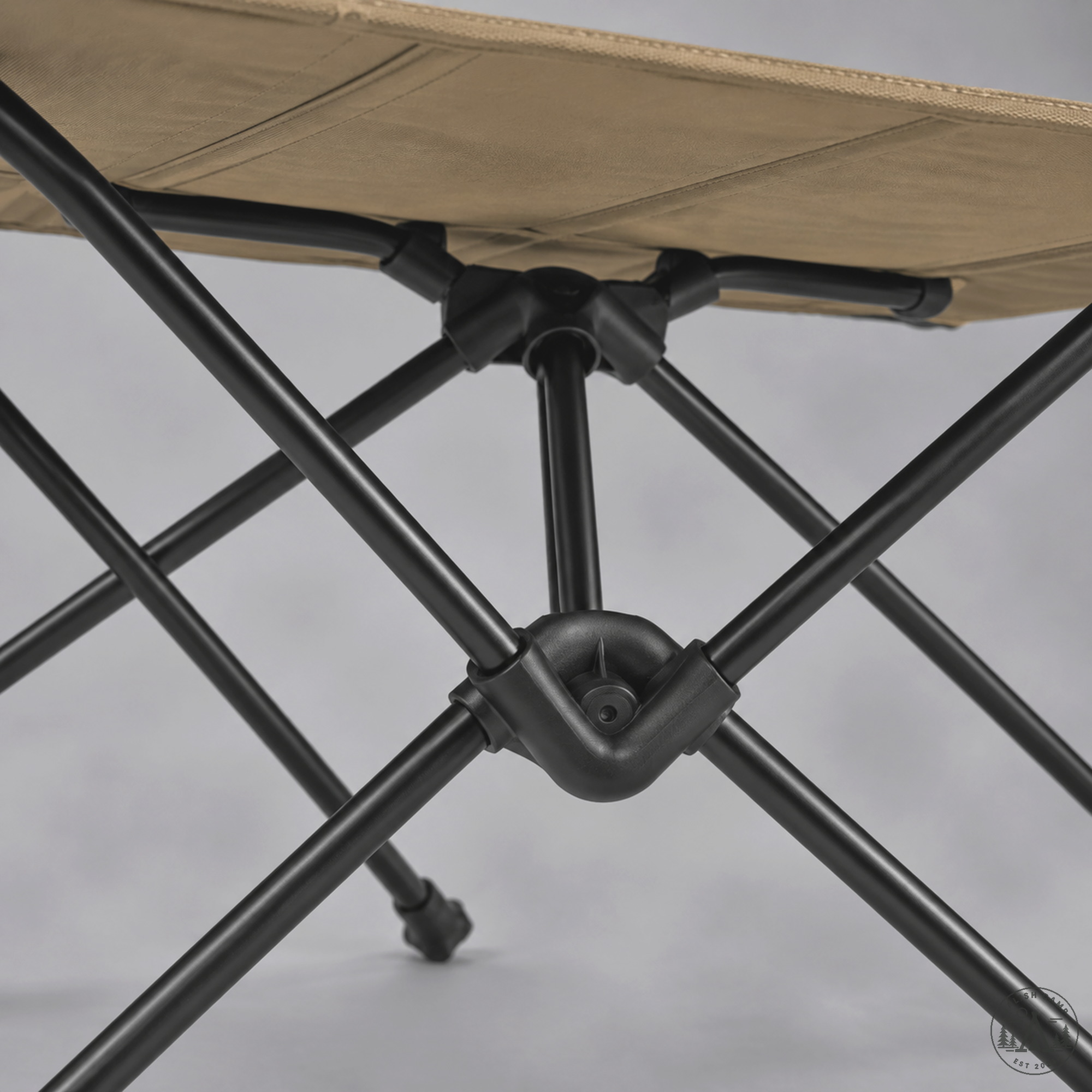 Helinox Table One Hard Top matte-black DAC resin hubs and shock-corded poles under Coyote Tan top