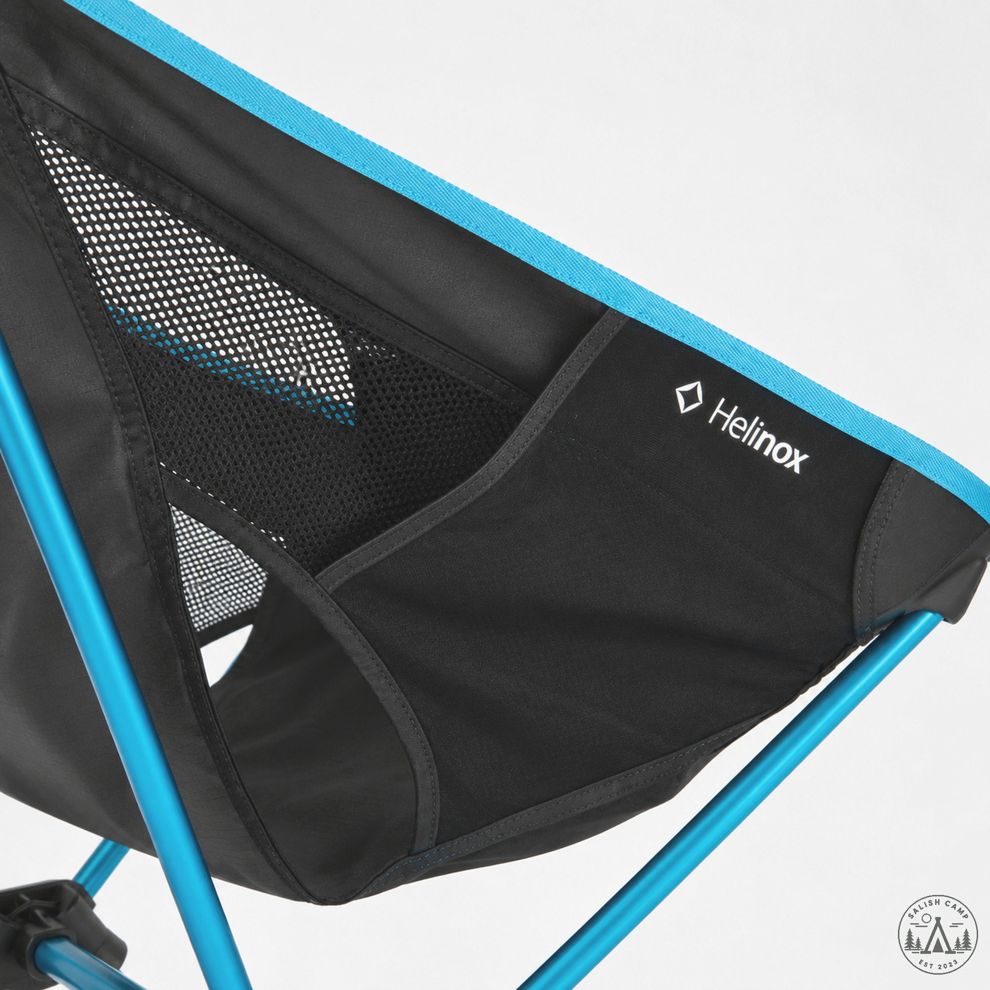 Close-up of the side panel on the Black Chair One High-Back (re), printed with a white Helinox wordmark