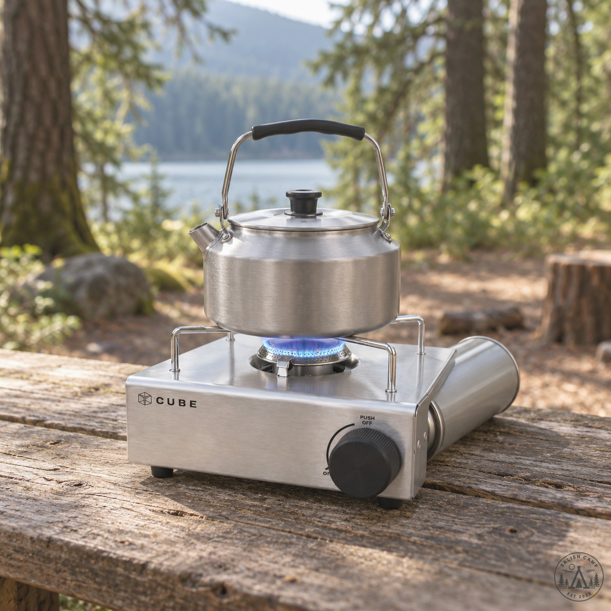 Kettle on a low flame on the Kovea Cube on a picnic table by a lake