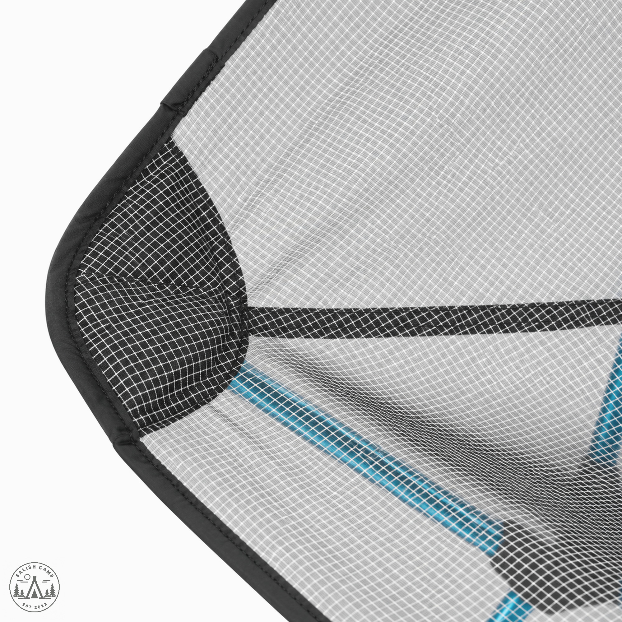 Close-up of a seat corner showing Ghostgrid grid mesh and a black reinforced corner
