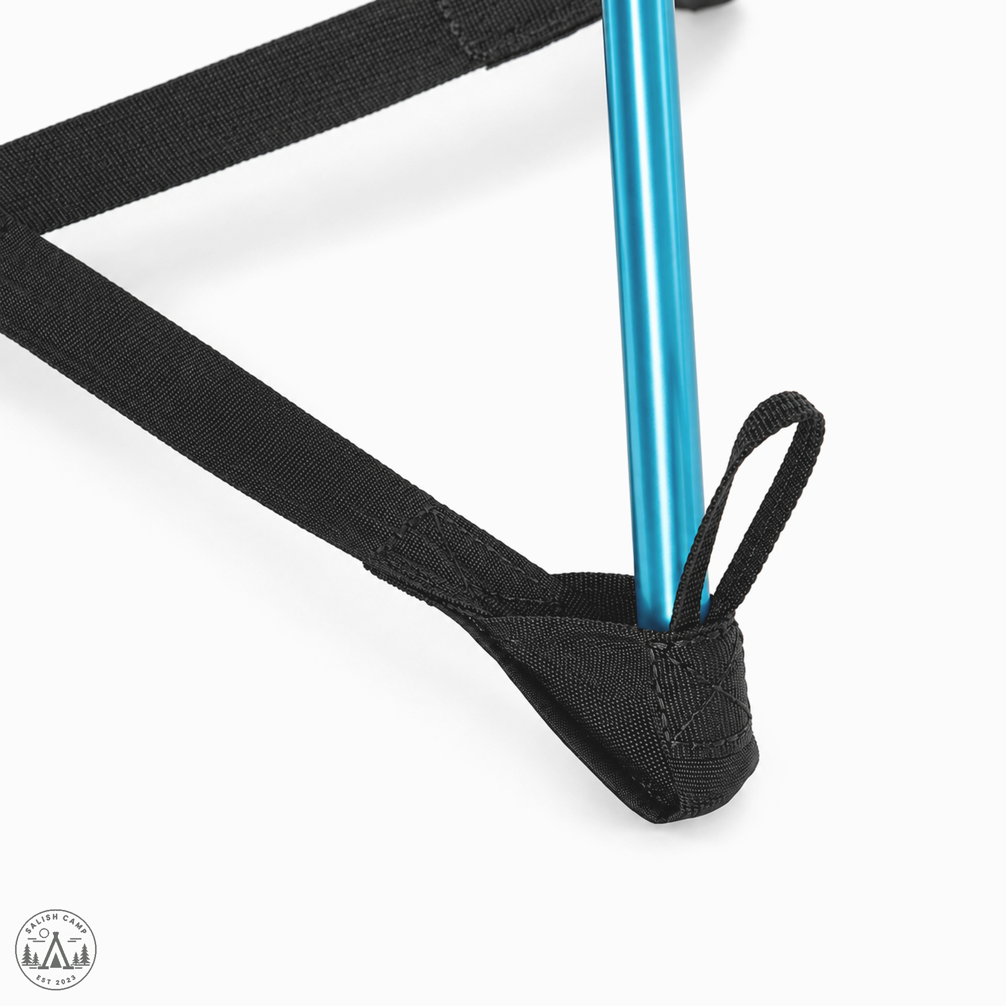 Close-up of the black X-Strap meeting a foot at a cyan leg