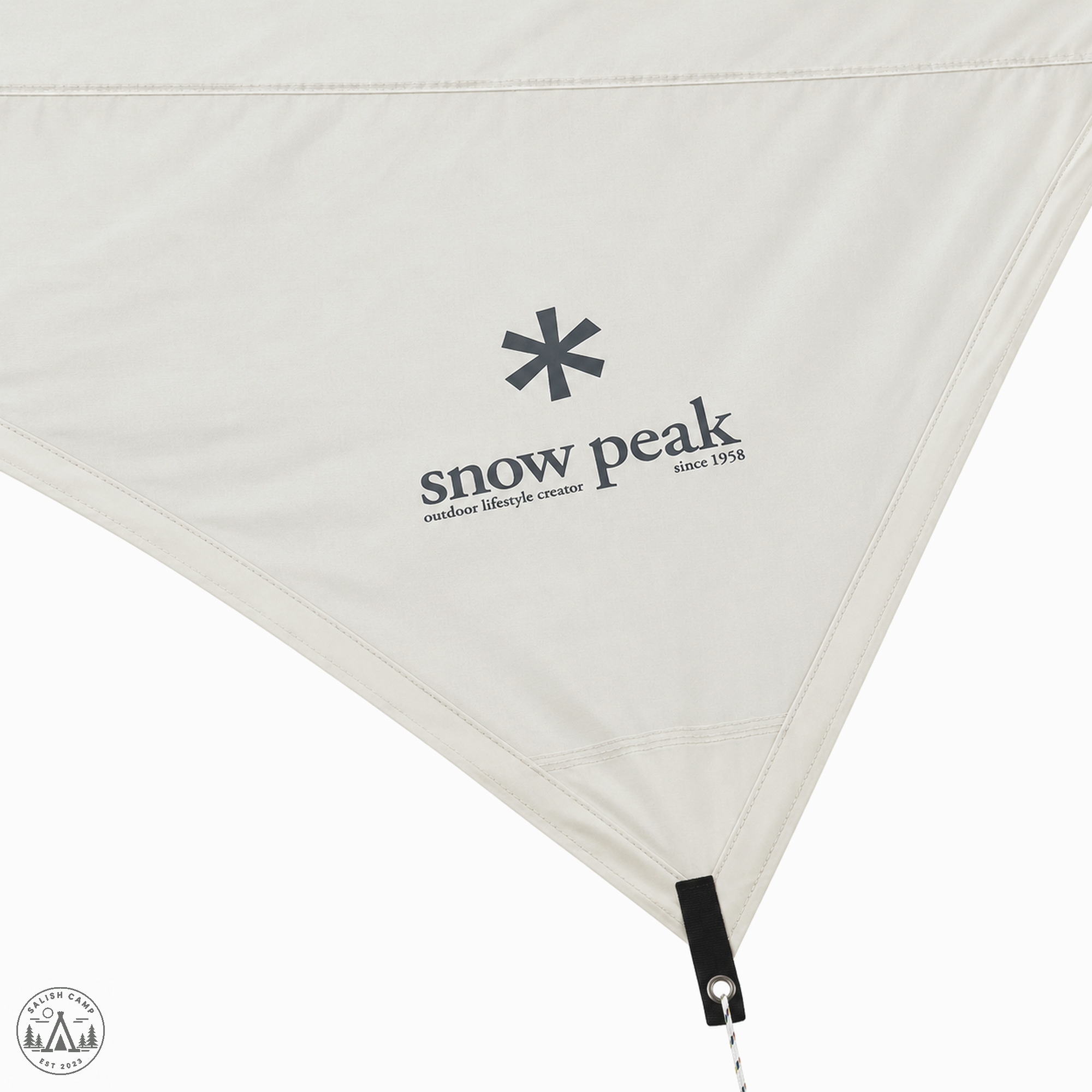 Close-up of the ivory Takibi Hexa panel with the Snow Peak asterisk, wordmark, and since 1958