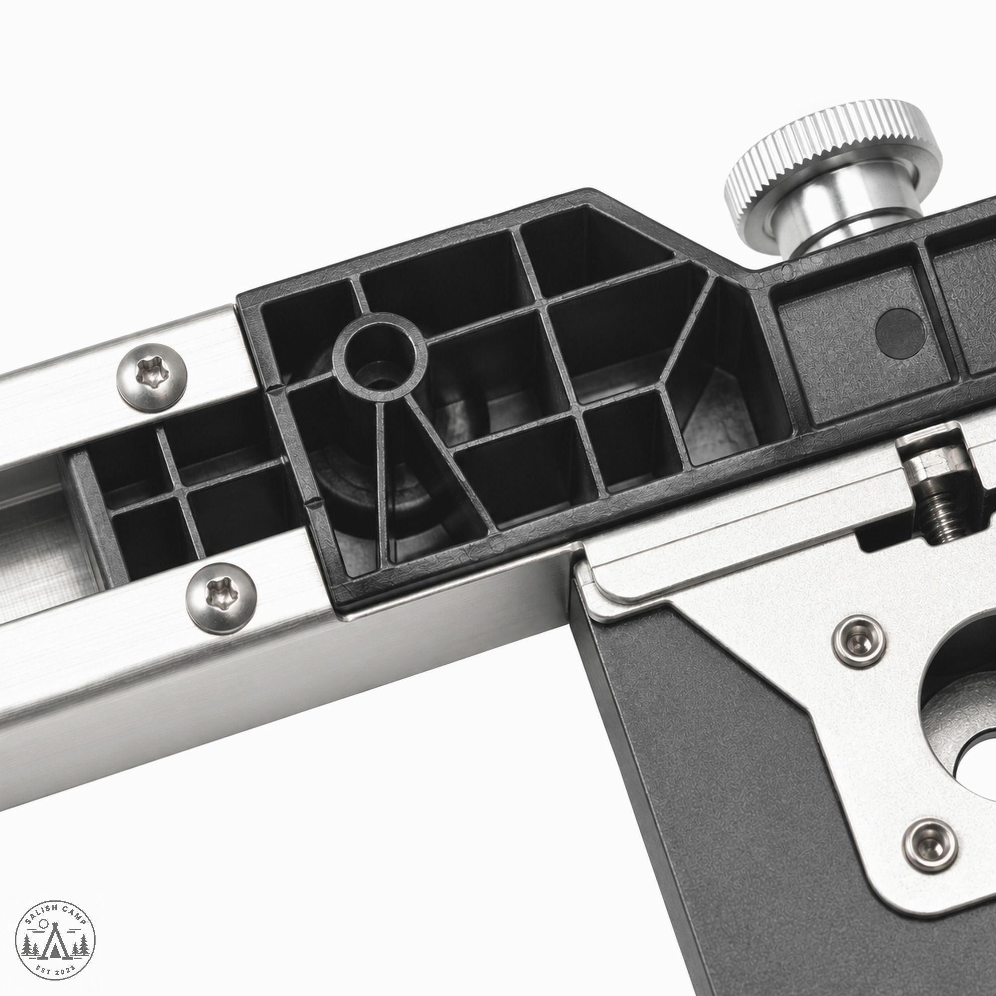 Black open lattice in a frame joint, with a knurled knob and screws on a silver bar