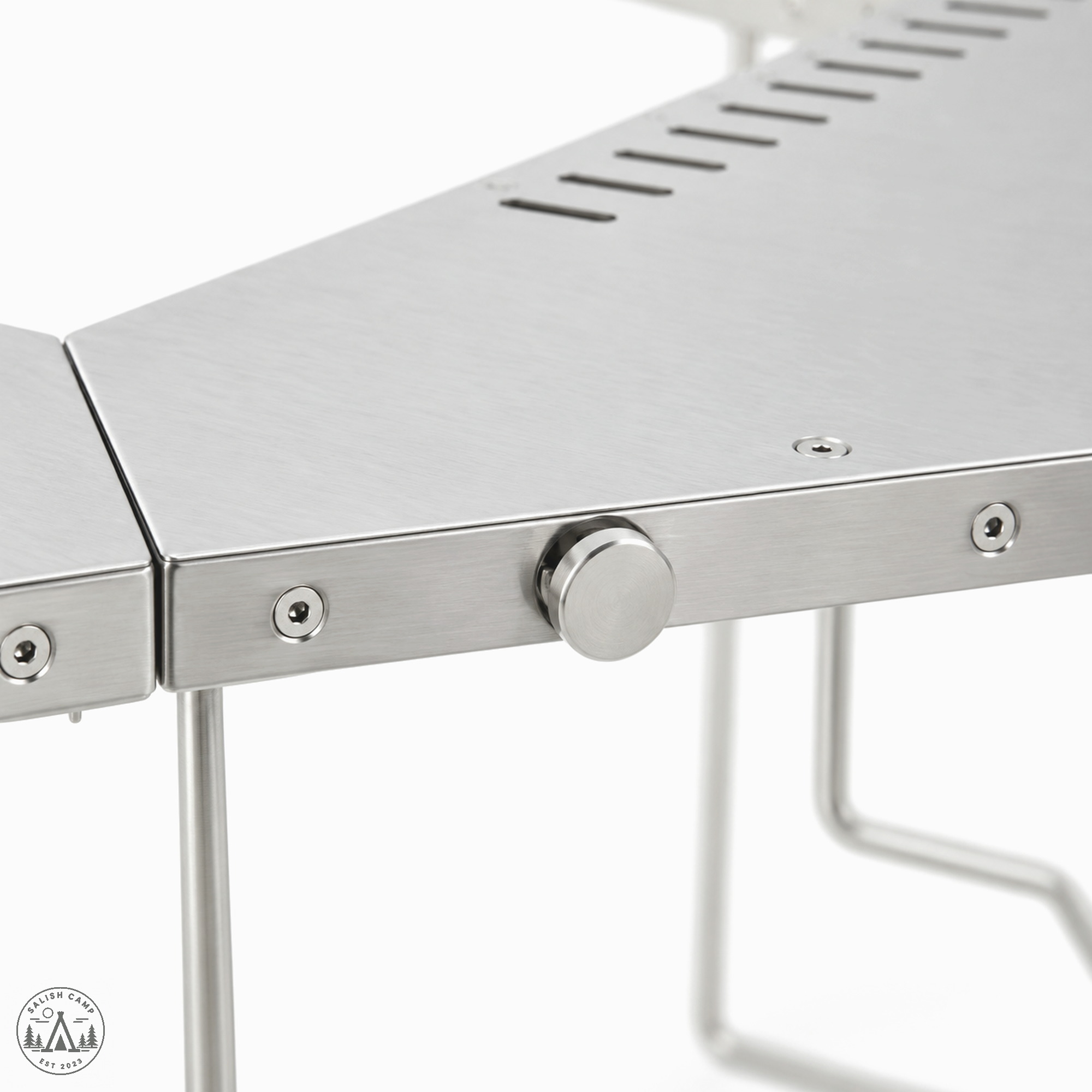 Close-up of one round knob on the outer edge of the Jikaro where two stainless tops meet