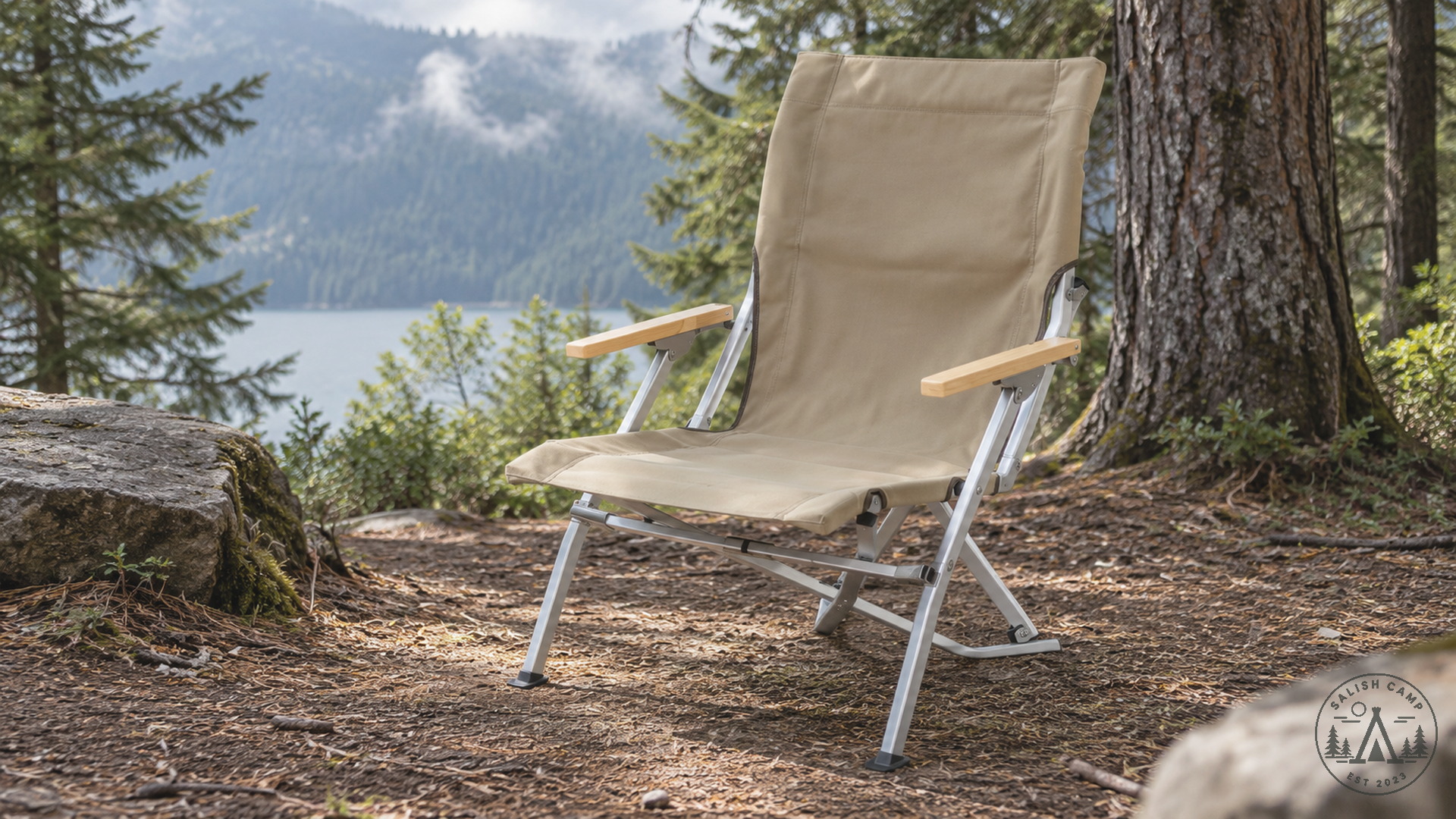 Empty Khaki Low Beach Chair on a dirt lakeside site with trees and rocks