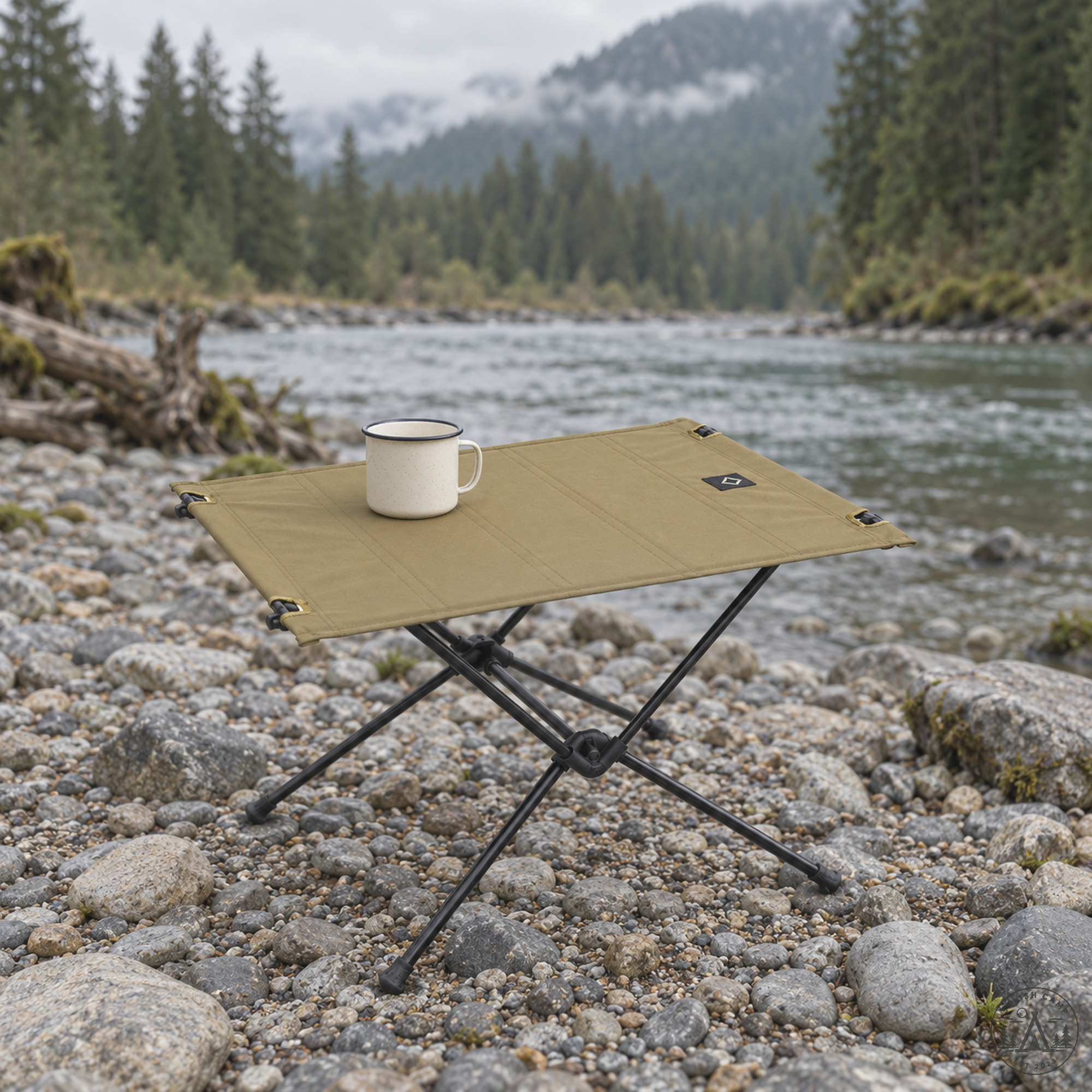 Helinox Tactical Table One on a river gravel bar with an enamel mug