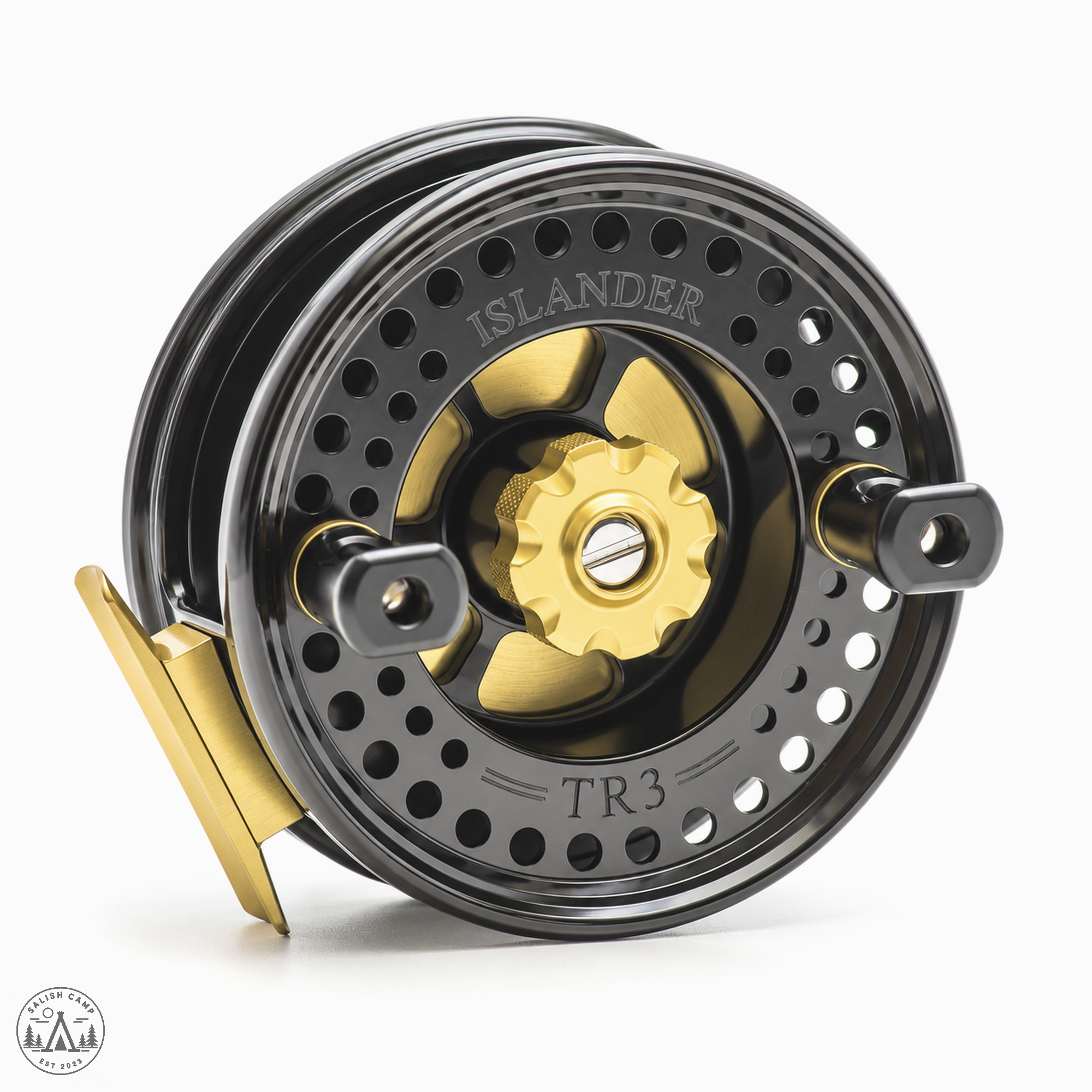 Black and gold Islander TR3 reel, three-quarter view of the spool face on white