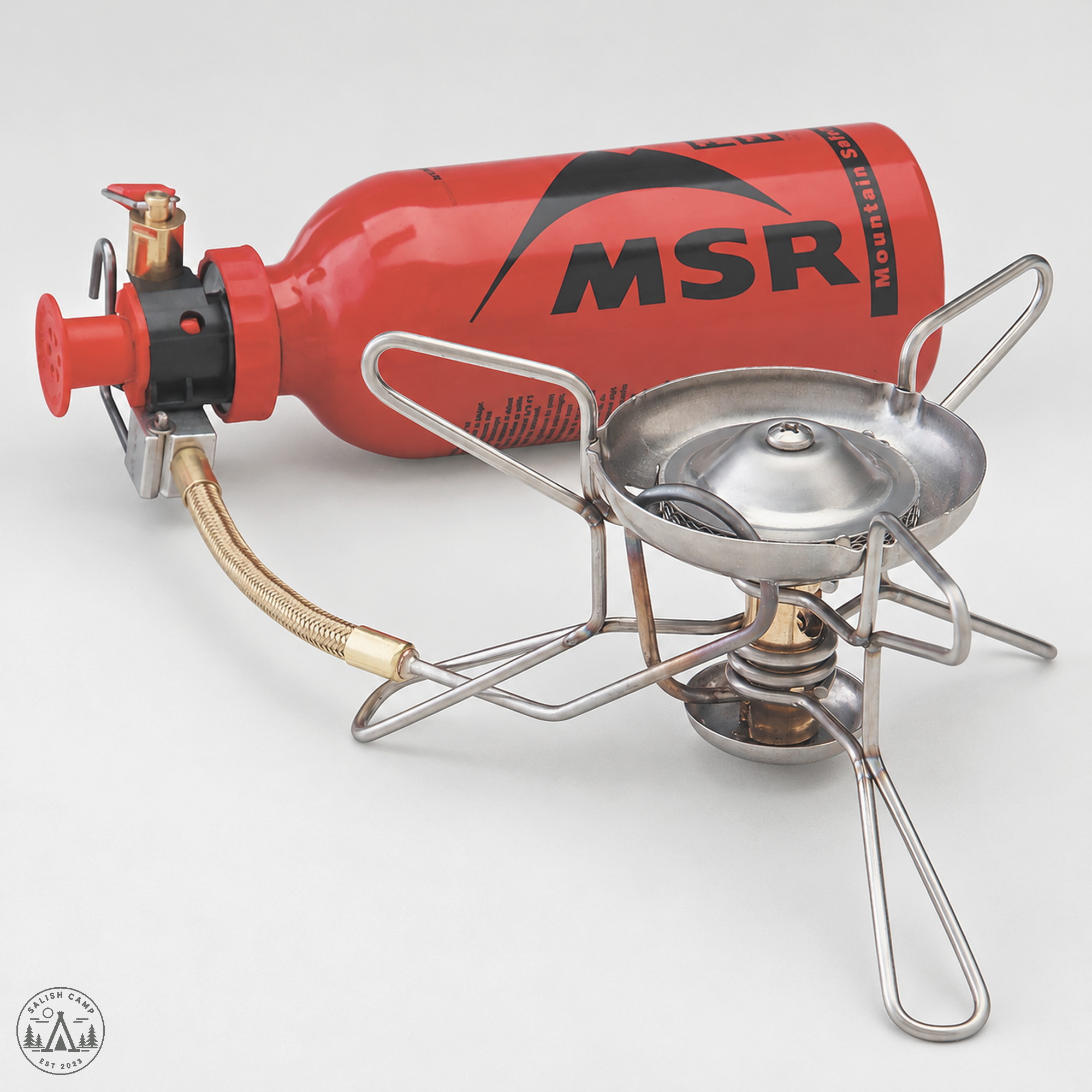 MSR WhisperLite stove assembled on a red MSR fuel bottle with pump
