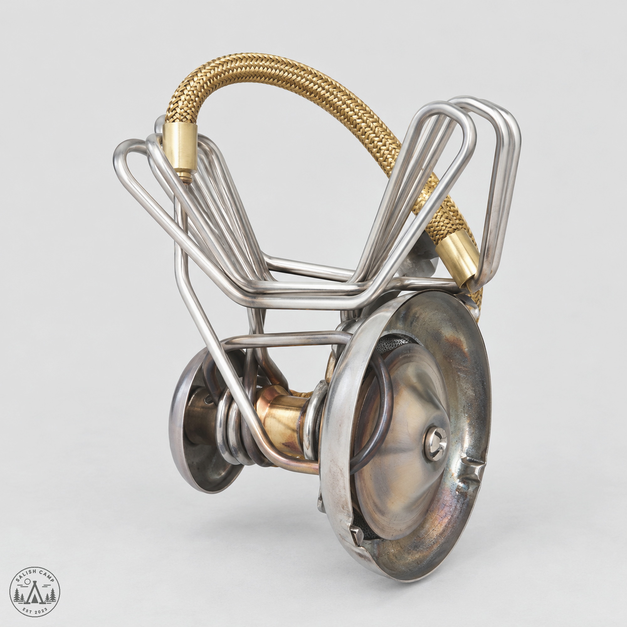 MSR WhisperLite stove alone with legs folded and fuel line coiled